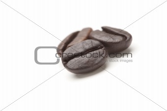 Three Roasted Coffee Beans Isolated on White with Narrow Depth of Field.
