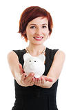woman holding piggy bank against white background