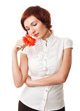 Beautiful woman with flower gerbera in her hands against white b