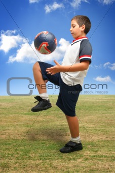 Kid playing soccer outside