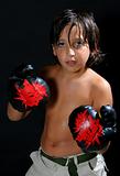 Boy boxing over a black background