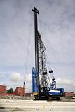 Pile driving rig picking up concrete pole