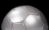 Close up of a silver football on black