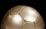 Close up of a gold football on black