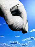 hand with glove and golfball