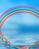 Rainbow reflected in blue ocean