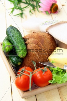 Picnic basket, bread, cheese and vegetables