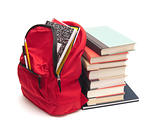 School backpack beside stack of book