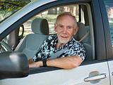 Old man at wheel of car