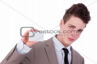 Young man with a blank business card in hand, isolated on white background. studio shot