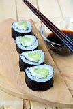 Japanese sushi rolls with cucumber with wasabi and chopsticks