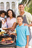 Family Enjoying A Barbeque
