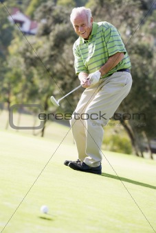 Man Playing A Game Of Golf