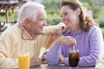 Couple Enjoying A Beverage By A Golf Course