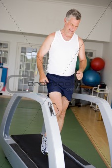 Man Running On Treadmill At Gym