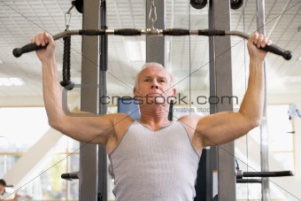 Man Weight Training At Gym