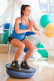 Woman Using On Balance Trainer At Gym