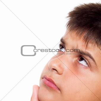 Close up, cropped  portrait of a young boy looking up, wondering, isolated on pure white background