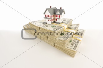 Stacks of One Hundred Dollar Bills with Small House on Slight Gradation.