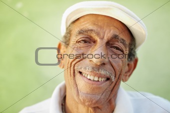 aged latino man smiling at camera