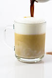 hot coffee latte in a glassy cup preparing