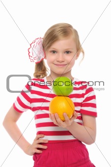Happy girl with orange and apple
