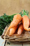 fresh baby carrots in a wicker basket