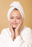 Happy Woman Getting Beauty Treatment Wearing Towel