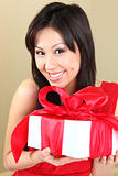 Asian Woman Holding a Gift Package Wrapped With Ribbon