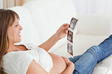 Attractive pregnant woman looking at a sonography