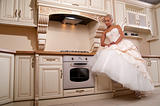 beautiful bride stands in the kitchen