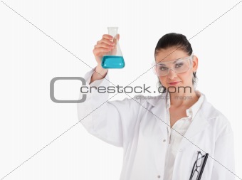 Dark-haired scientist holding a blue flask