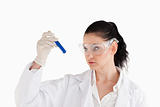 Dark-haired scientist carrying out an experiment