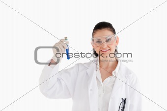 Isolated scientist looking at the camera while holding a test tu