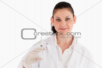 Doctor with syringe looking at the camera