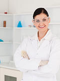 Dark-haired woman with safety glasses posing
