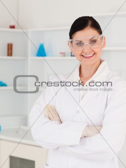 Dark-haired woman with safety glasses posing