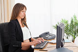 Charming pregnant woman working with a computer