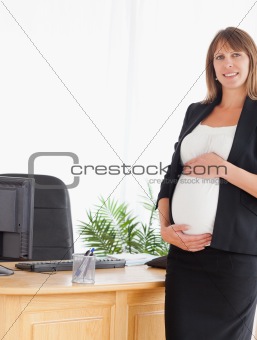 Beautiful pregnant female posing while standing