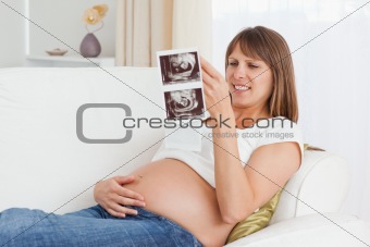 Pregnant woman looking at her baby's ultrasound scan