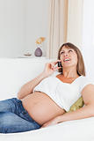Portrait of a happy pregnant woman phoning