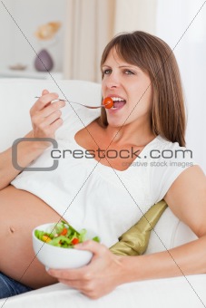 Close up of a mother to be eating a salad