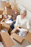 Female Generations of Family Unpacking Boxes Moving House