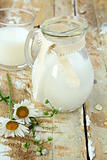 pitcher of milk on a wooden table rustic still life