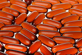 closeup bright orange capsules background