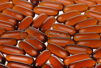 closeup bright orange capsules background