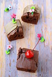 brownie chocolate cakes with cherries on a brown background