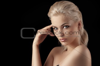 seductive young blonde woman on black