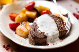 Rustic beefsteak with cream sauce and pan cooked vegetables