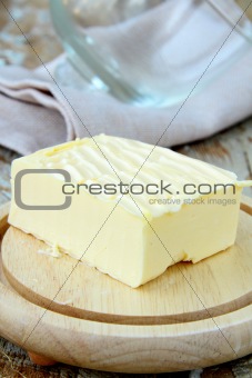 fresh yellow butter on a wooden stand, organic produce